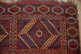 Tattered fringe, geometric medallions, and patterns in cherry brick red, navy, and pale gold on an antique Beshir runner, circa 1910s.