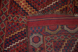 Antique Beshir rug's geometric motif border and striped flatweave end showing wear.