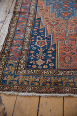 Intricate floral borders and serrated medallion edge on a vintage Malayer runner's corner.