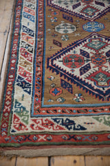 The intricate serpent-inspired main border of an antique Caucasian rug runner.