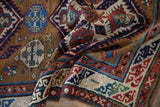 A folded view reveals the intricate serpent motif and time-softened pile of an antique rug.