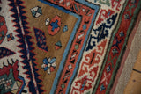 Low pile and visible knot heads on the serpent-inspired border of an antique Caucasian rug.
