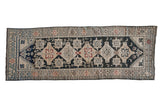 Distressed Karabagh runner with stacked geometric medallions in charcoal, ivory, and terra cotta.