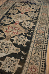 Stylized animal and bird motifs on a distressed Karabagh runner with a detailed pawn design border.