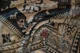 Hand-knotted texture of an Armenian Karabagh rug showing charcoal animal and bird figures.