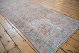 Distressed vintage Mahal runner with faded terra cotta and pale blue floral palmettes and blossoms.
