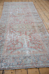 Distressed Mahal rug runner with pale terra cotta and dusty blue floral motifs, showing mostly even wear.