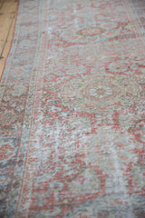 Distressed Mahal runner's worn pile, showing foundation and muted terra cotta, blue hues.