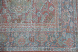 Distressed vintage Mahal rug corner, pale terra cotta and dusty blue floral motifs, with wear.