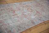 Distressed Mahal rug runner detail: faded pale terra cotta and blue floral patterns, foundation visible.