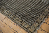 Faded field and exposed foundation of a distressed Anatolian runner with starburst border.