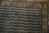 Distressed geometric water motif with a starburst border in ivory, brown, and dusty gold.
