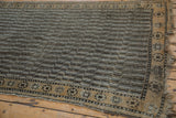 Distressed Anatolian runner: tattered fringe, starburst border, and worn water motif.