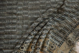 Distressed Anatolian runner showing worn texture and chocolate brown, ivory water design.