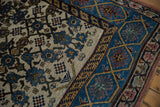 Textured corner detail of the distressed Bijar runner with blue geometric border.