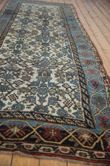 Distressed Kurdish Bijar runner with worn ivory field and sky blue cartouche border.