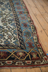 Distressed Kurdish Bijar runner corner: worn ivory Herati field, sky blue border with finned blossoms.