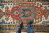 Textured detail of distressed antique Persian Kurdish runner, madder red and sky blue.