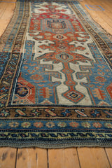 Distressed geometric medallion of antique Kurdish runner in sky blue, madder root red.