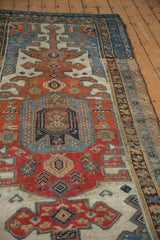 Antique Kurdish rug, distressed pile showing madder red and blue geometric patterns.