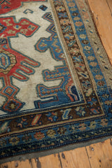 Decorative distressed edge and geometric borders on this antique Kurdish runner in varied blues and reds.