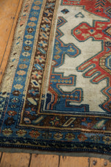 Distressed indigo blue outer border and tattered edge of antique Kurdish rug runner.