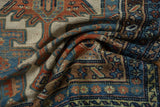 Distressed hand-knotted pile and knot heads on the antique Kurdish runner, indigo and rust.