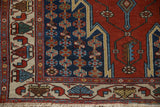 Stepped corner spandrel and columns of floral motifs on a hand-knotted vintage Hamadan rug.