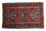 Vintage Fine Heriz rug with triple medallion, floral pinwheels, and vine border in cherry red and navy.