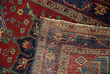Hand knotted Heriz rug folded corner shows worn cherry red pile and original polychrome selvage.