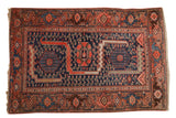 Vintage Malayer rug with sprawling navy blue triple medallion field and fuchsine red patterned border.