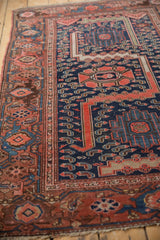 Malayer rug's main border with meandering vine, Herati, samovar turtle motifs, navy and fuchsine tones.