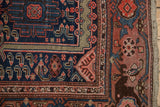 Navy cloudband field meets dusty blush samovar turtle border on a vintage Malayer rug.