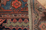 Hand-knotted Malayer rug's side selvage and geometric navy, red, beige border pattern.