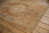 Decorative distressed Malayer rug, showing textured Herati medallion with ivory and blush.