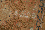 Distressed vintage Malayer rug with worn Herati design, visible foundation, and fringe.