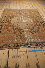 Distressed Malayer rug's worn end border with indigo blue vinery and partial fringe.