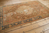 Distressed end border detail of a vintage Malayer rug with indigo blue and pale blush.