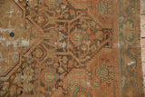 Distressed vintage Malayer rug detail: exposed foundation, worn floral patterns, blush, bronze, indigo.