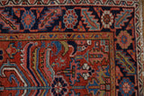 Vintage Heriz runner detail: navy and brick red geometric motifs with sky blue accents.