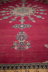 Cherry red field of vintage Khorassan carpet to stylized navy, sky blue border, unfinished edge.
