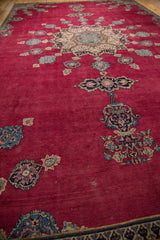 Intricate floral bud motifs on cherry red field of a vintage Persian Khorassan carpet.