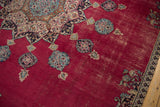Cherry red field with intricate floral motifs, visible foundation, vintage Persian Khorassan carpet.