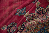 Vintage Khorassan detail: cherry red field, exposed foundation, and intricate floral motifs.