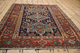 Karaja rug's madder red border featuring Samovar Turtle motif and navy blue geometric field.