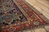 Vintage Karaja rug border with madder root red Samovar Turtle design and navy blue geometric field.