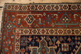 Vintage Karaja rug's geometric buds on madder red field and Samovar Turtle motif border.