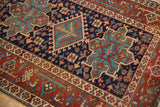 Navy blue field with geometric buds, blossoms, and a madder root red Samovar Turtle border.
