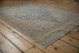 Distressed Malayer rug displaying faded Herati field and meandering palmette main border.