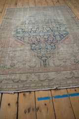 Distressed texture and worn edge of a Vintage Malayer rug, showing visible foundation and fringe.